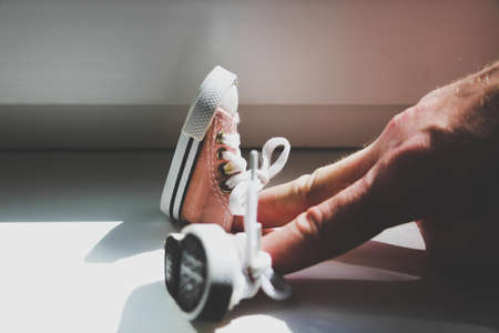 Setting - fingers are dressed in sneakers. Seated position.の写真素材