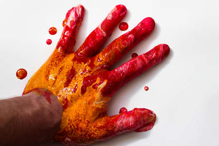 Fully hand in paint of different colors on a white background.の写真素材