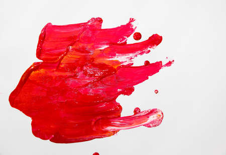 Paint on white background - red with elements of other colors.の写真素材