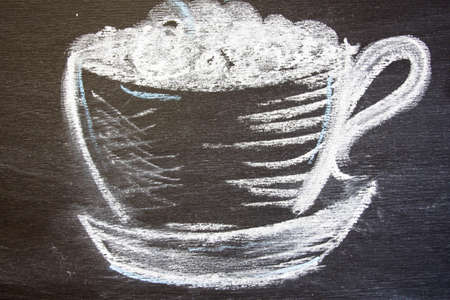 A cup of coffee is drawn on a black board.の写真素材