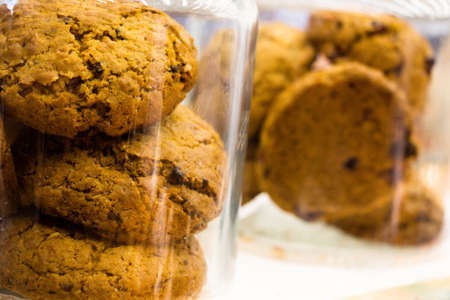 Oatmeal cookies in a glass jar in a bakery.