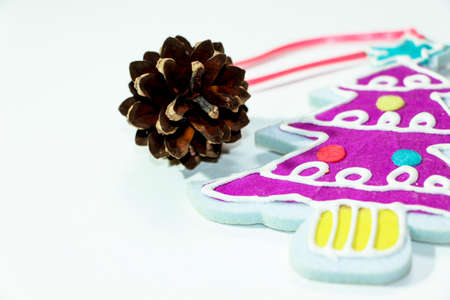 Christmas decoration in the form of a little decorated with garlands and balls of a Christmas tree...
