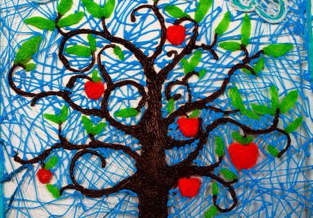 Beautiful fruit tree with fruits on a white background. Bright red fruits and wood are made of plastic.の写真素材