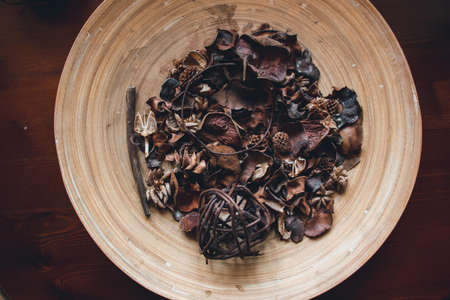 In the wooden plate are lined with beautiful fruit cones, ears of grass, dried fruit details and...