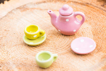 A small teapot and two cups stand on a wooden background. Small cake Everything is ready for tea.の写真素材