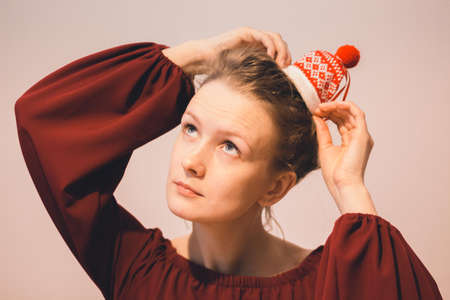 A red hair girl is wearing a red sweater. Bunny girl's head is tied with hair patternsの写真素材