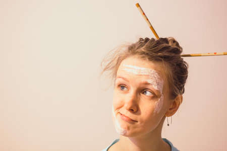 Girl with her hair on a white background. Girl with astonished look of face.の写真素材