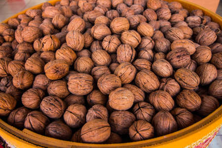 In the container is a lot of walnuts. Walnuts are very tasty and healthy.の写真素材