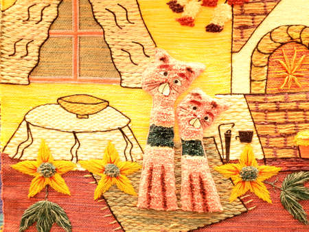Beautiful embroidery with various bright threads. Two beautiful and fluffy cats are sitting in a...