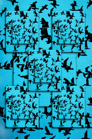 Set of black silhouettes of birds on a blue backgroundの写真素材