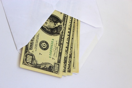 dollar banknotes in envelope as a bribe isolated on a white backgroundの写真素材