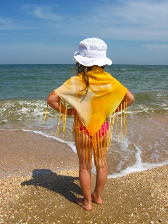 girl in bathing suit standing at the seacoastの写真素材