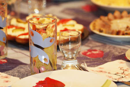 crockery glass plate wine-glass and dishes on the served tableの写真素材