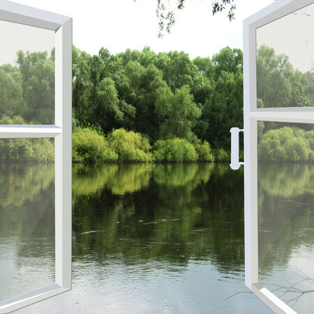 opened window overlooking the spring floody riverの写真素材