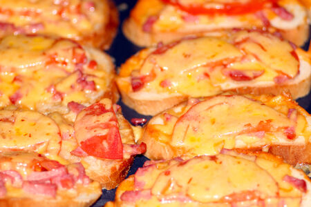 hot sandwiches with smoked sausage and melted cheese on the plateの写真素材