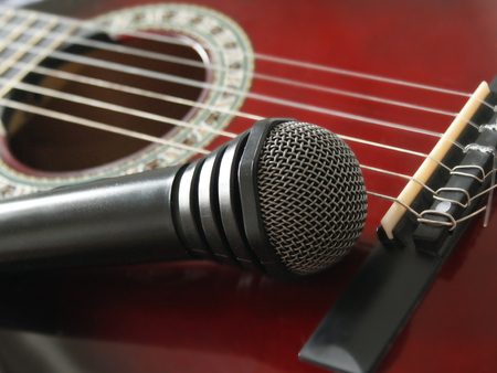 guitar and microphoneon the wooden dark backgroundの写真素材