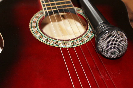 dark red guitar and fragment of microphone