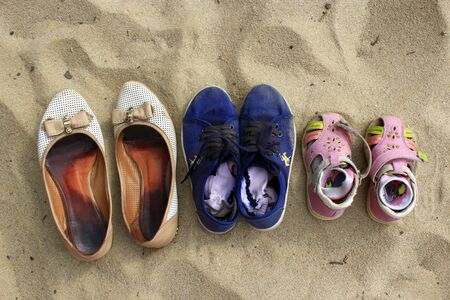footwear left by mother and her daughters whith went to swim in the riverの写真素材
