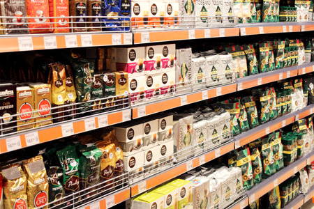 shop with a lot of different coffee packets on the shelves in supermarketのeditorial素材
