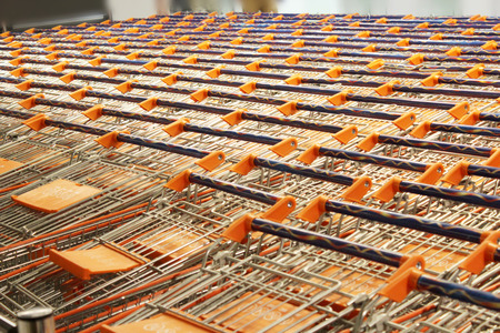 a lot of small carts standing in row in supermarketの写真素材