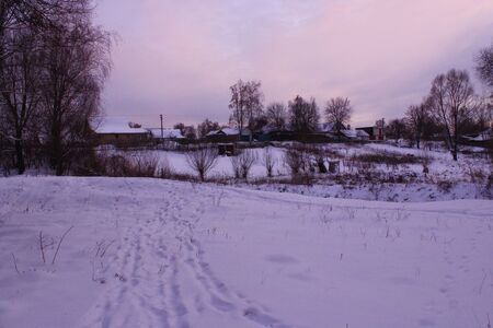 winter landscape with evening village in snowの写真素材