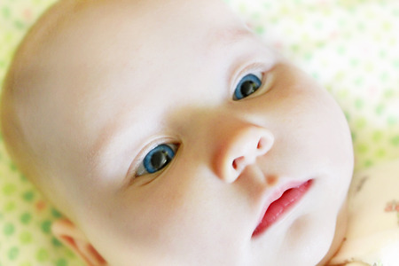 face of nice baby with big blue eyesの写真素材