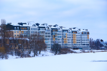 modern and new multi-storey houses with nice architecture on the banks of the winter riverの写真素材