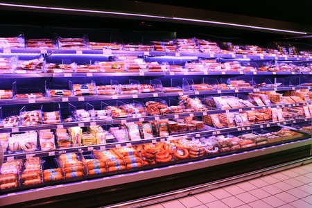 Sausages in shop. Wide choice of different sausages and meat products on shelves of shop. Sausages in shop.のeditorial素材