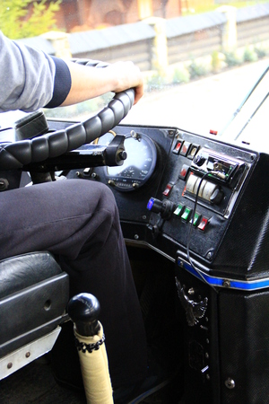 Driver is driving bus. Driver switching gear lever in bus. Dashboard in the busの写真素材
