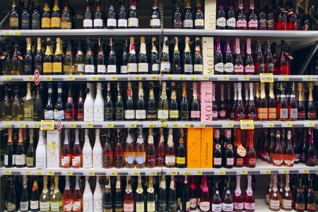Champagne shop. Wide selection of champagne and wine in department of alcoholic beverages in supermarket. Alcoholic drinks on shelves of supermarket. Store of alcoholic drinksのeditorial素材