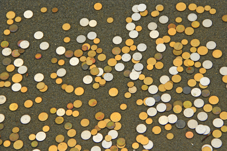 Ukrainian coins scattered on floor. Ukrainian metallic money white and yellow. Ukrainian small coin. Small changeの写真素材