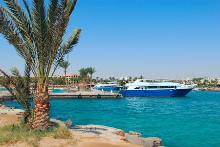 View of embankment of Hurghada with moored yachts, ships and beautiful palm trees. Modern Egyptian city. Seafront of Hurghada. View of Egyptian city of Hurghada from Red seaのeditorial素材