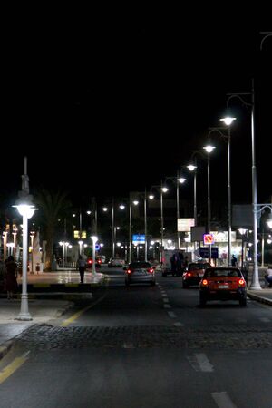 View of night street of Hurghada with lanterns and cars. Night city of Hurghada. City life at night. Road and night lighting in city. Streets of Hurghada illuminated in eveningのeditorial素材