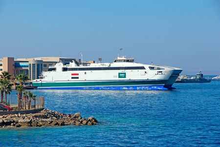 Cruise liner with tourists sailing on Red Sea. Sea voyage on white boat. Cruise ship with tourists on Sea. Mass tourism on seaのeditorial素材