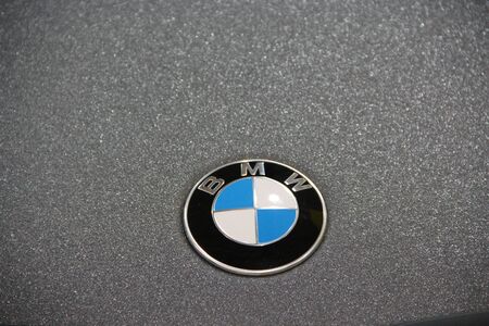 BMW car icon on gray background. Symbol manufacturer of cars BMW. White and blue sign of German brand auto BMWのeditorial素材