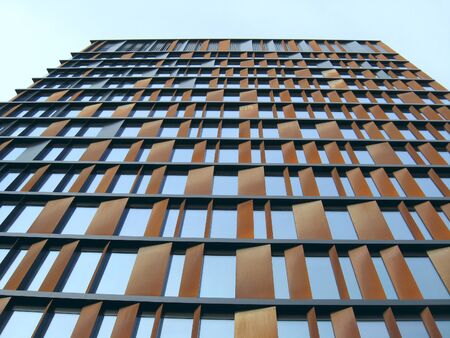 Skyscraper in Lodz. Tall skyscraper with blue windows in Lodz. Modern building with equal windows...
