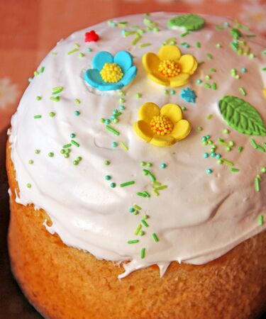 Easter bread decorated by meringue and edible leaves with flowers. Delicious Easter bread home-made...