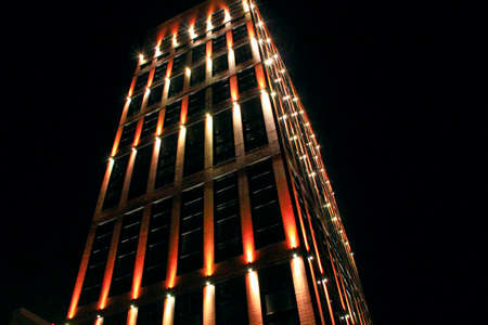 Beautiful illumination on modern skyscraper in night city. illuminated building. Building with beautiful lighting at night in Lodz. Night illumination on modern building. skyscraper in night lightsのeditorial素材