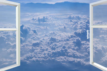 Window of room overlooking blue sky with white clouds. Opened window with sky panorama. Heavenly...