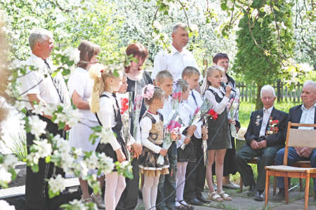 Young children congratulate the veterans of the Second World War on Victory Day. Schoolchildren and war veterans celebrate the anniversary of the end of war in May 2010のeditorial素材