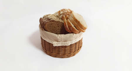 Vine wicker basket isolated on white background. Bread basket. Pieces of bread in a bread basket....