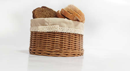 Vine wicker basket isolated on white background. Bread basket. Pieces of bread in a bread basket....