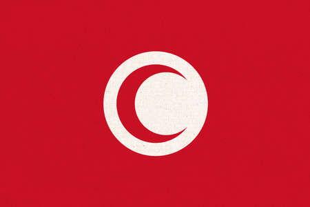 Flag of Tunisia. Tunisian flag on fabric surface. fabric texture. National symbol of Tunisia on...