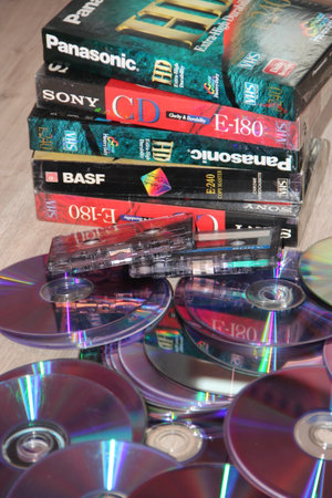 CDs, cassettes, video cassettes. Attributes of the 1990s. memory entries. video memory recording. Hobby of the 90s. Passion for music in the 1990s. Compact disks video and audio tapesのeditorial素材