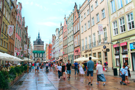 Modern architecture in Gdansk. Rush hour in city street. European city. European tourists walking...