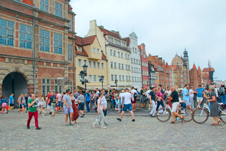 Modern architecture in Gdansk. Rush hour in city street. European city. European tourists walking...