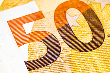 Macro shot of the number 50 on a euro banknote, showing detailed print texture, fine lines, and...