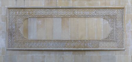 Oriental patterns on the stone wall