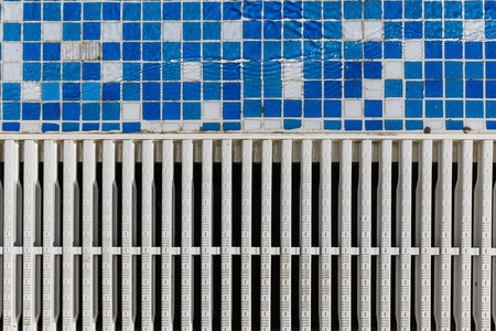 A tile with a groove and the water draining rack in the poolの写真素材