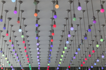 Installation of multi-colored light bulbs on the ceilingの写真素材